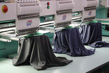 Dress shirts being embroidered